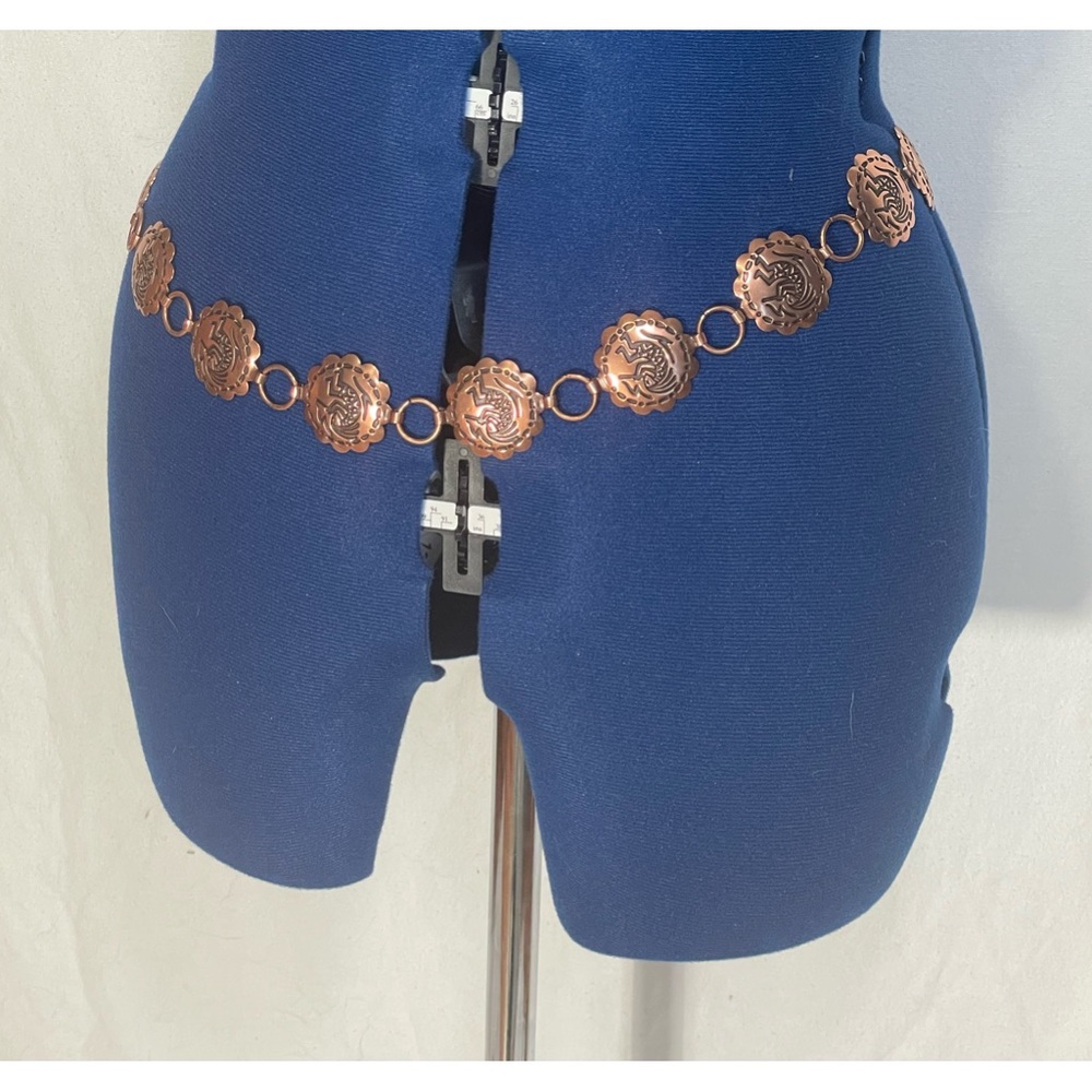 Copper belt with kokopeli symbol.